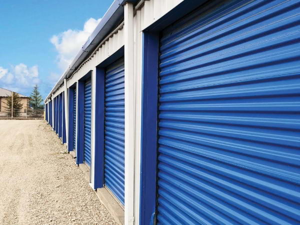 outside storage unit with blue doors and white framing