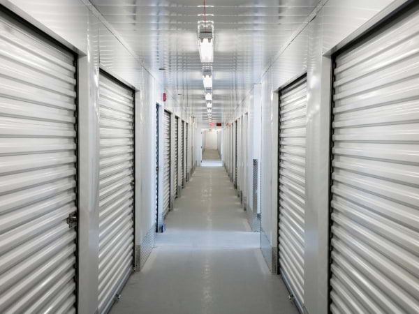 A storage unit hallway with fluorescent lights